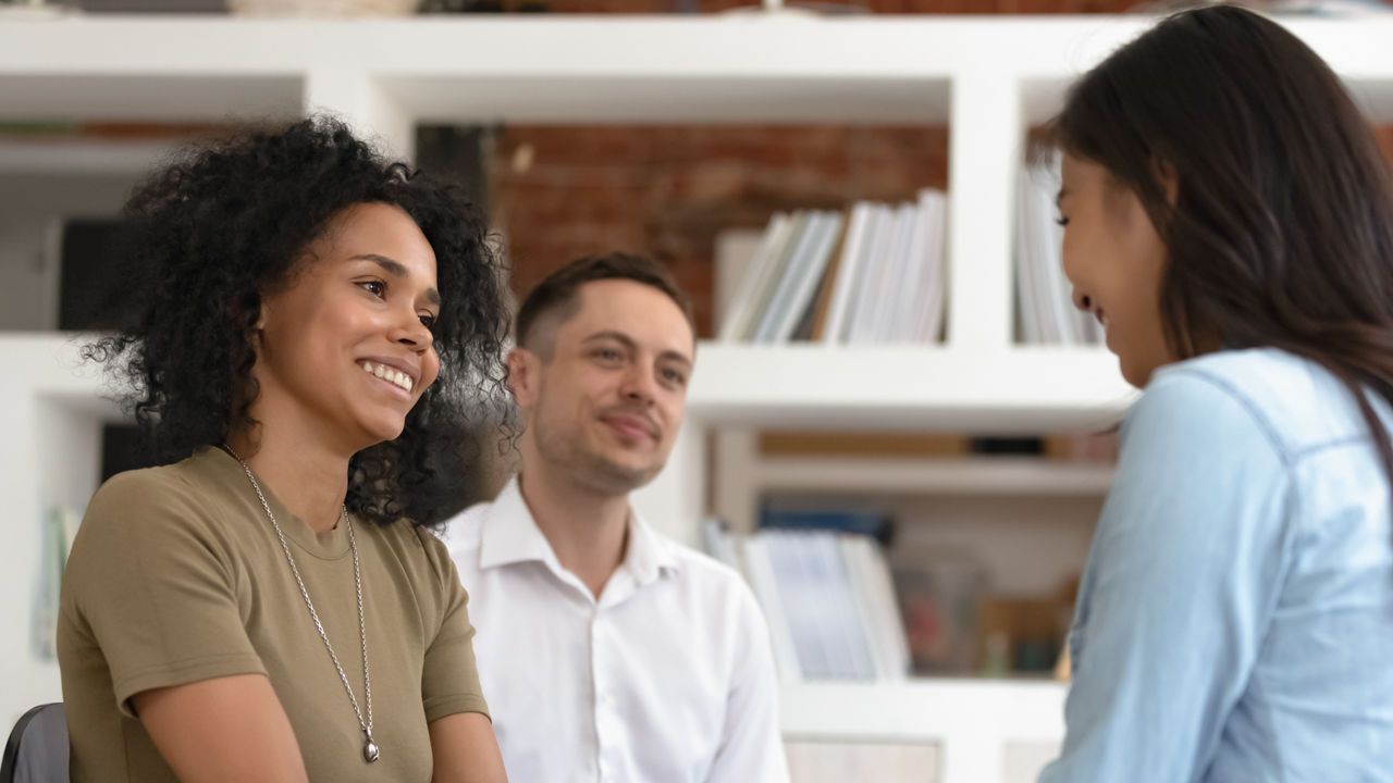 Duplicate - Higher Res - Repurchased 4/21/2023, Asian and African American women holding hands during group therapy session, diverse friends feeling reconciled relief smiling giving psychological support empathy overcome problem at psychotherapy counseling