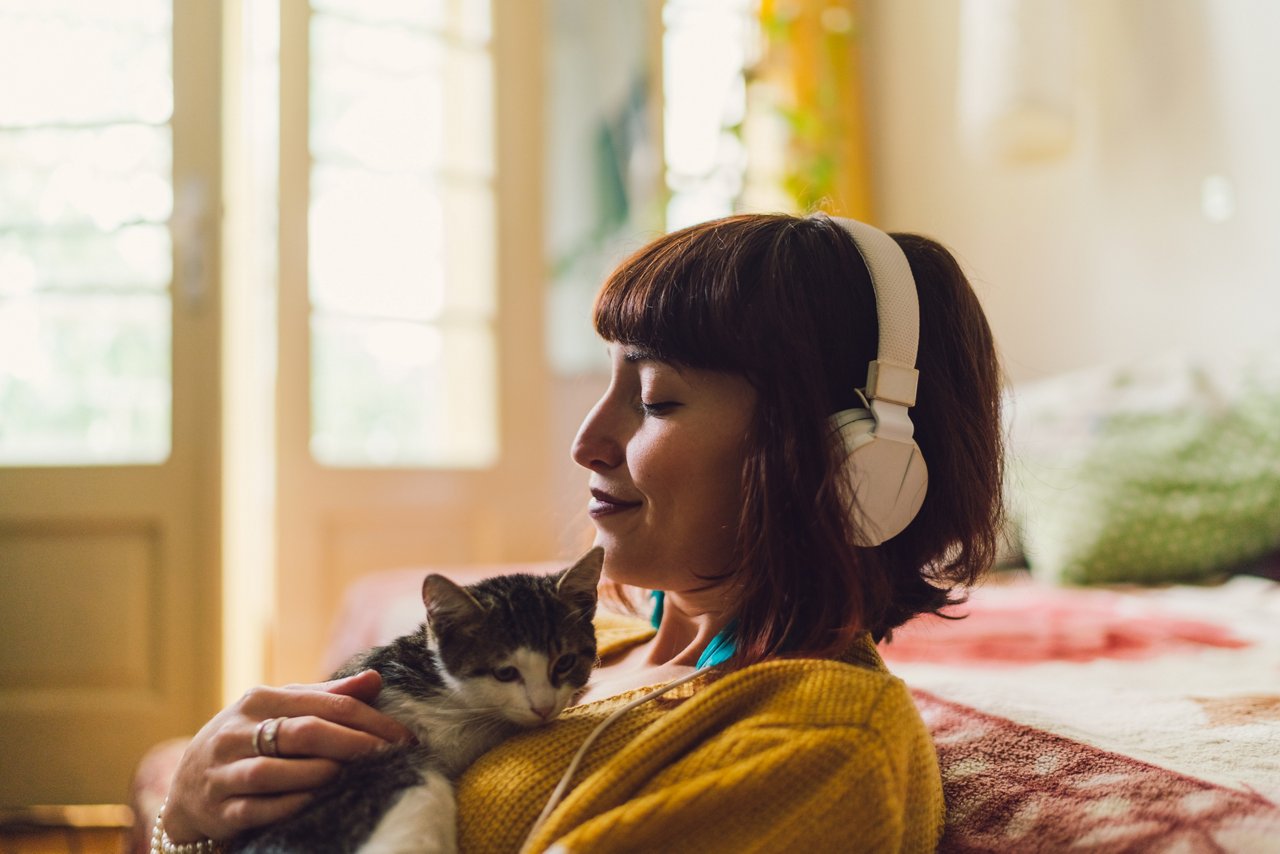 Female with cat at home relaxing during the weekend