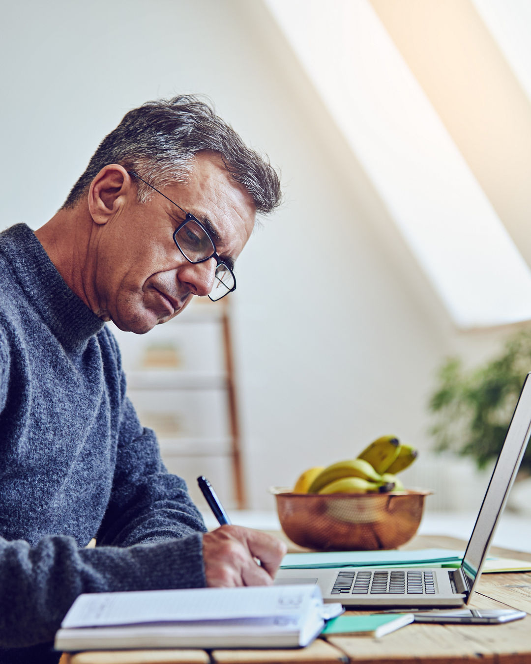 Shot of a senior man using a laptop at home